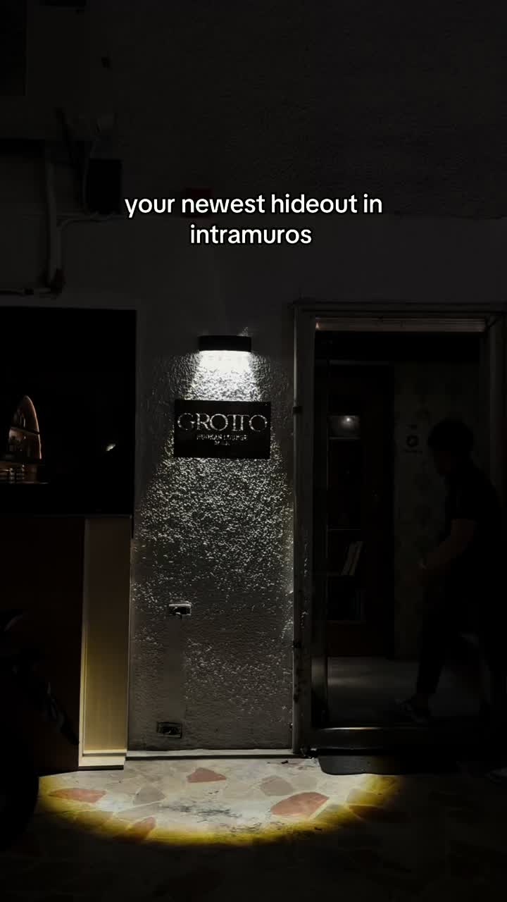 Grotto Hookah Lounge entrance with illuminated sign in Intramuros